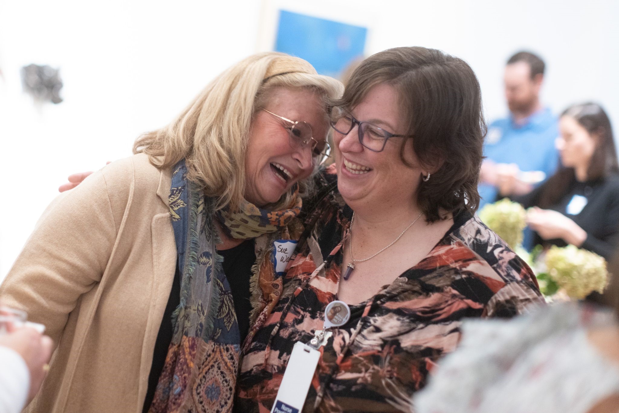 Two nurse practitioners laugh together at APP Week reception