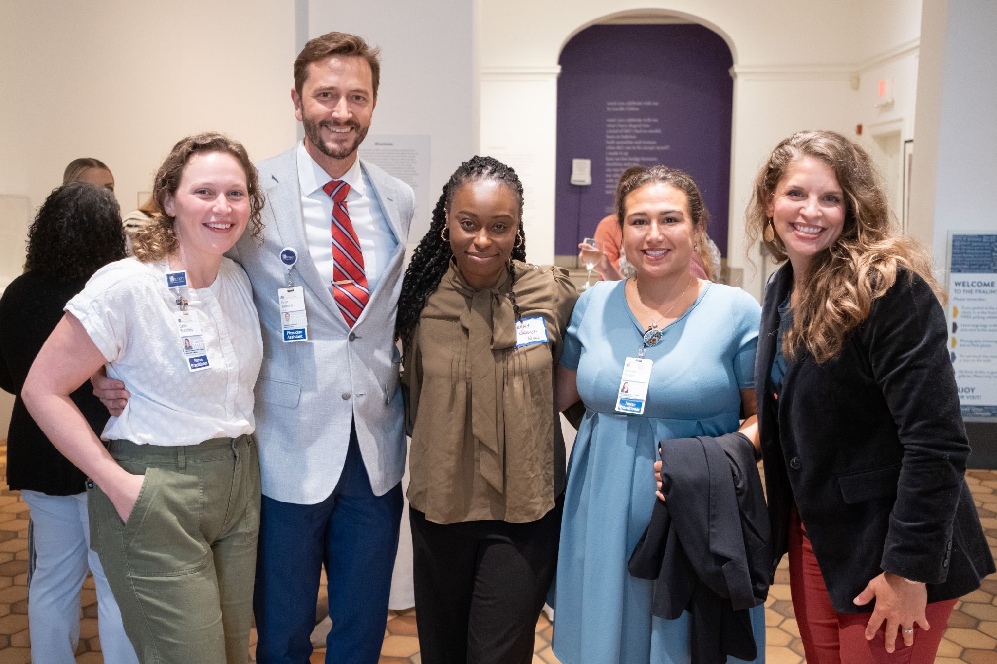 A group photo of five Advanced Practice Providers stand together smiling